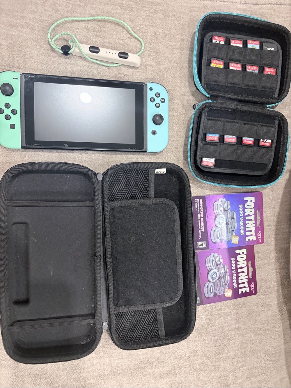 Nintendo Switch with Mint Green and Light Blue Joy-Con and Game Carrying Case
